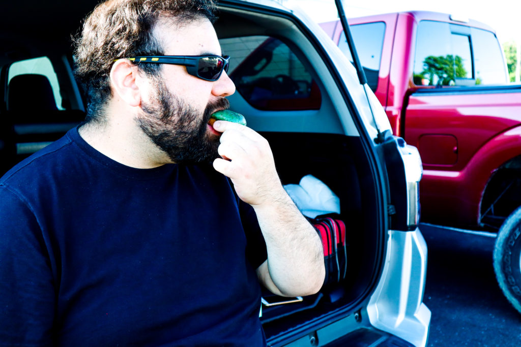 Peter eating a Sandy Pony Donut in the trunk.
